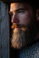 Bearded man in chainmail gazes thoughtfully into the distance photo