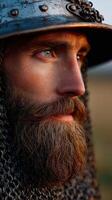 Warrior in medieval armor with a long beard at sunset photo