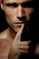Silence conveys mystery in a close-up portrait of a man photo