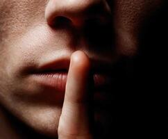 Quiet gesture of secrecy displayed by a person's lips photo