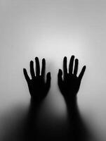 Hands reaching out against a soft, illuminated background photo