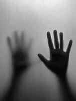Hands pressed against a foggy glass surface during a quiet moment photo