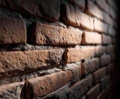 Texture of weathered brick wall illuminated in warm tones photo