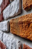 Close-up view of textured bricks in various tones on a wall photo