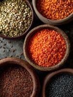 Colorful assortment of spices and lentils in rustic bowls photo