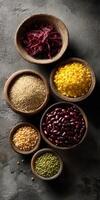 Colorful selection of dried spices and legumes arranged in bowls photo