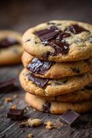 Delicious homemade chocolate chip cookies stacked on a wooden table photo