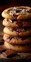 Tempting chocolate chip cookies stacked on a wooden table photo
