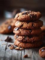 Delicious chocolate chip cookies stacked on rustic wooden surface photo
