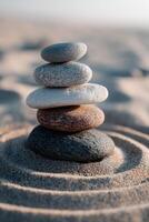 Stacking stones creates balance and harmony on sandy beach at sunset photo