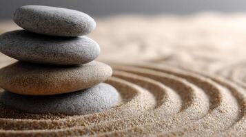 Stacked stones creating tranquility on sandy surface in calming setting photo