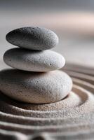 Stacked stones creating balance in a serene sand arrangement photo