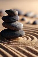 Balanced stones create harmony on smooth sand surface at tranquil setting photo