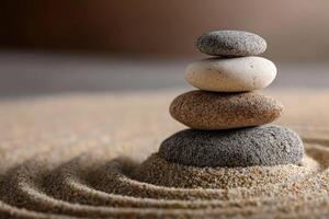 Stones stacked on sand with ripples in a peaceful, minimalist setting photo