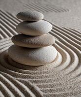 Stacked stones create a calming sand pattern in a tranquil setting photo