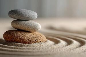 Stacked stones create harmony in raked sand at a tranquil setting photo