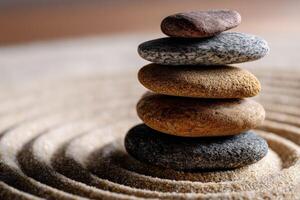 Five stacked stones on a sandy surface create a calming arrangement photo