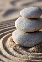 Calm and balanced stone stack in rippling sand at a tranquil location photo