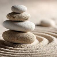 Stones stacked in harmony on a smooth sand surface creating calmness and balance photo