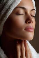 Woman relaxing with peaceful expression during skin care routine at home photo