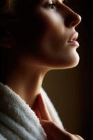 Woman in a robe contemplating in soft light during a tranquil moment photo
