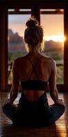 Woman practicing yoga at sunset in a serene mountain setting photo