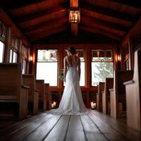A bride standing in the chapel at a wedding photo