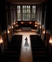 Bride stands alone in an elegant chapel waiting for wedding ceremony photo
