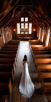 Bride walking down aisle in rustic chapel during afternoon light photo