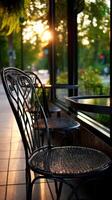 Charming cafe setting with sunlit chairs and tables on a warm evening photo