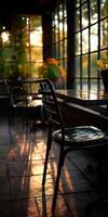 Sunset light filtering through windows in a cozy indoor space with chairs photo