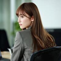 Professional woman in office setting looks back with focus photo