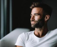 Man relaxing indoors while enjoying a moment of tranquility during daylight photo