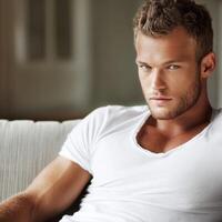 Young man relaxing on a sofa in bright room during daytime photo