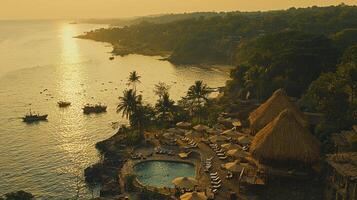 A view of a beach and a resort with a pool photo