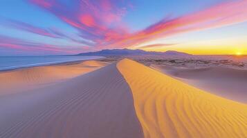 Sunset over the desert with sand dunes and mountains in the background photo