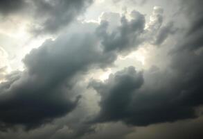 cloudy sky with a plane in the foreground photo