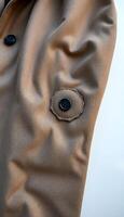 close up of a coat with a button on it photo