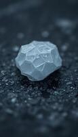 piece of ice sitting on top of a black surface photo