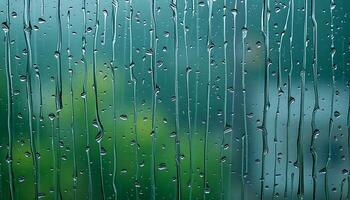 rain drops on a window with green grass in the background photo