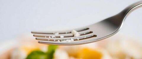 close up of a fork with food on it photo