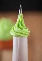cupcake with green frosting on top of it photo