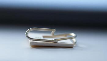 pair of metal clips sitting on top of a table photo