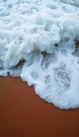 close up of a wave on a sandy beach photo