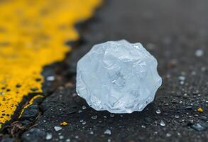 piece of ice sitting on the side of a road photo