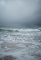 view of a body of water with waves coming in photo