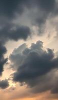 plane flying through a cloudy sky at sunset photo