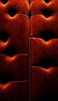 close up of a red couch with a black background photo