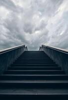 set of stairs leading up to a cloudy sky photo