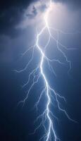 lightning bolt striking through a dark blue sky photo